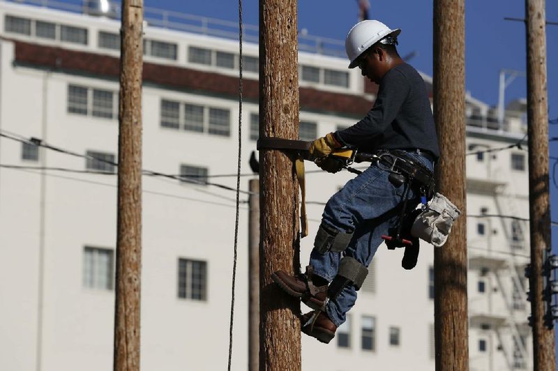 A student training to become an electrical lineman ascends a pole during class at Los Angeles Trade-Technical College in Los Angeles, California, U.S., on Wednesday, March 12, 2014. The U.S. Department of Labor is scheduled to release initial jobless claims figures on March 20. Photographer: Patrick T. Fallon/Bloomberg