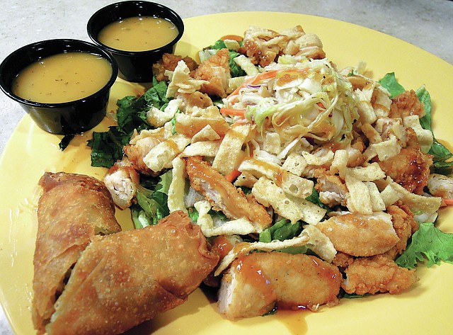 Crispy wontons, honey sesame dressing and Asian slaw top the Zensation Zalad at Zaxby&#8217;s.