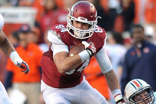 Arkansas tight end Hunter Henry makes a catch as he tries to shake Auburn defender Jake Holland during the second quarter of a Nov. 2, 2013 game at Razorback Stadium in Fayetteville.