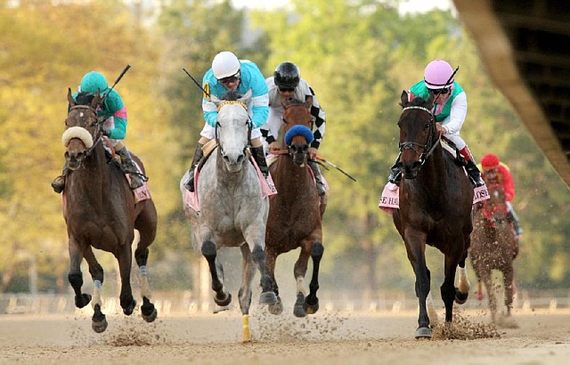 Close Hatches, with Joel Rosario aboard (right), crosses the finish line to win the Apple Blossom Handicap at Oaklawn Park in Hot Springs by 1¼ lengths, preventing On Fire Baby (second from left) from winning the race for a second consecutive time. Stanwyck (left) finished third. 