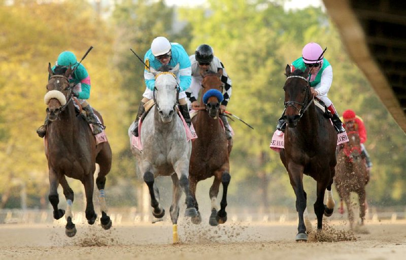 Close Hatches, with Joel Rosario aboard (right), crosses the finish line to win the Apple Blossom Handicap at Oaklawn Park in Hot Springs by 1¼ lengths, preventing On Fire Baby (second from left) from winning the race for a second consecutive time. Stanwyck (left) finished third. 