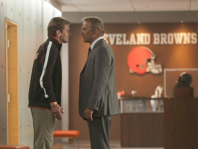 Cleveland Browns head coach Vince Penn (Denis Leary) faces off with general manager Sonny Weaver Jr. (Kevin Costner) in Draft Day, Ivan Reitman’s sports dramedy about the NFL draft. 
