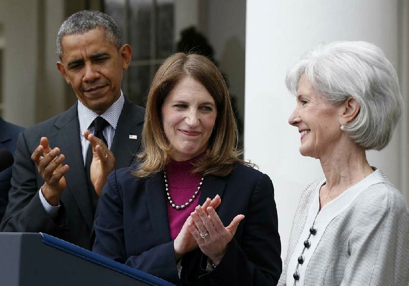 President Barack Obama and his nominee for the top job at the Health and Human Services Department, Sylvia Mathews Burwell, applaud the outgoing leader, Kathleen Sebelius, during Obama’s announcement of the nomination Friday in the White House Rose Garden.