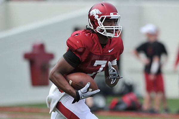 Arkansas quarterback Damon Mitchell runs back a punt as the Razorbacks run drills before the start of Saturday's football scrimmage at Razorback Stadium in Fayetteville.