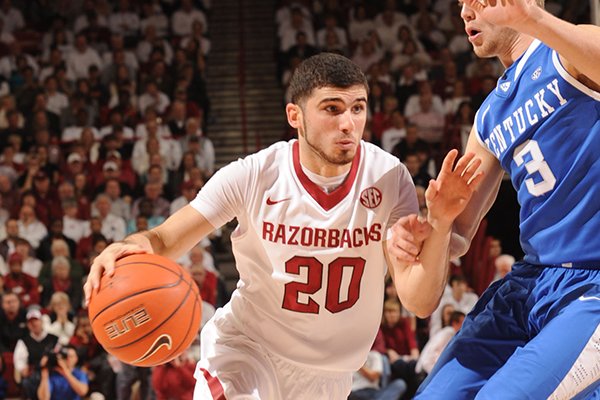 Arkansas guard Kikko Haydar (20) drives as Kentucky guard Jarrod Polson defends during the first half of play Tuesday, Jan. 14, 2014, in Bud Walton Arena in Fayetteville.