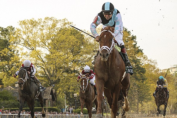 Jockey Joe Bravo aboard Danza crosses the finish line to win Saturday's Arkansas Derby at Oaklawn Park in Hot Springs Saturday.