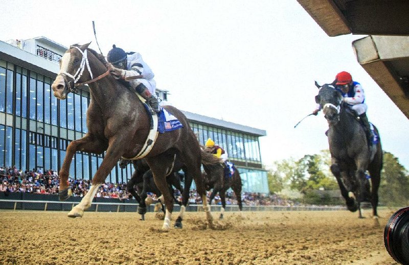 4/12/14
Arkansas Democrat-Gazette/STEPHEN B. THORNTON
Jockey Luis Saez aboard Will Take Charge, left, crosses the finish line to win Saturday's  Oaklawn Hadicap at Oaklawn Park in Hot Springs Saturday.