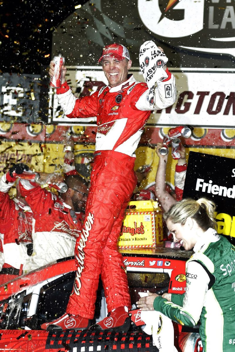 Kevin Harvick celebrates in Victory Lane after winning the NASCAR Sprint Cup auto race at Darlington Raceway in Darlington, S.C., Saturday, April 12, 2014. (AP Photo/Chuck Burton)
