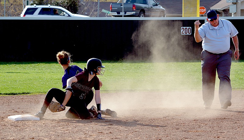 Graham Thomas/Siloam Sunday Siloam Springs pitcher Crissa Spry looks up as umpire Gary Trembly calls her out at second base as &#0010;Berryville&#8217;s Morgan Pando applies the tag.