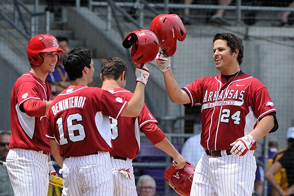 Arkansas' Blake Baxendale (24) connects on a grand slam home run in the first inning of a game against LSU Sunday, April 13, 2014 at Alex Box Stadium in Baton Rouge, La. Arkansas won 10-4. 