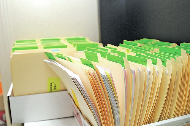 STAFF PHOTO SAMANTHA BAKER • @NWASAMANTHA Complaints for small claims court are stored in boxes Friday at Springdale District Court.