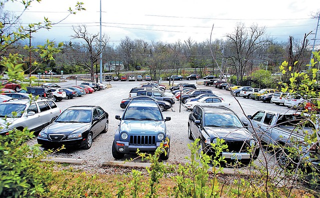 STAFF PHOTO DAVID GOTTSCHALK The University of Arkansas has a temporary parking lot at the south west corner of the intersection of Douglas Street and Gregg Avenue in Fayetteville where a proposed parking garage will be build.