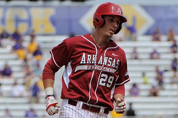 Arkansas' Eric Fisher rounds third base after hitting a two-run home run in the fifth inning of a game against LSU Sunday, April 13, 2014 at Alex Box Stadium in Baton Rouge, La. Arkansas won 10-4. 