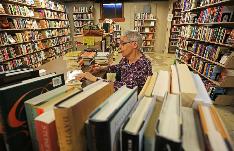 FILE — Joan Mohnhaupt prices and tags donated books at the bookstore in the Cox Building in the Little Rock River Market in this April 14, 2014 file photo. 