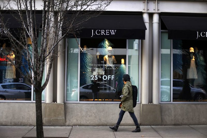 In this March 24, 2014 photo, a pedestrian passes a J.Crew store in the Shadyside shopping district of Pittsburgh. The Commerce Department reports on retail sales for March on Monday, April 14, 2014. (AP Photo/Gene J. Puskar)