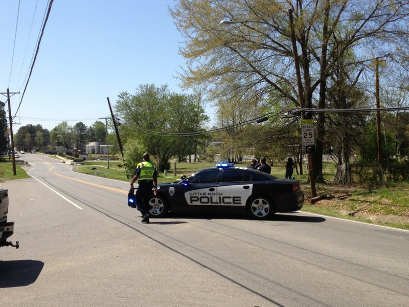 Little Rock police set up a roadblock at Chicot Road and Yorkwood Drive, near Chicot Elementary School, on Tuesday morning, April 15, 2014.