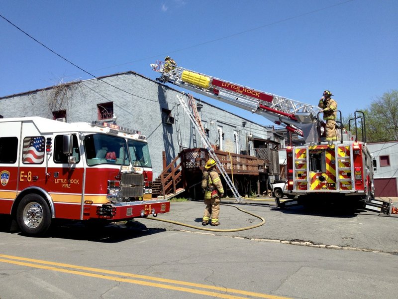 Little Rock fire officials work Tuesday, April 15, 2014, at Pizza D'Action, 	2919 W. Markham St. in Little Rock.
