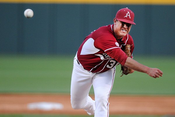 Arkansas' Jacob Stone delivers a pitch Tuesday, April 15, 2014, during the game against Stephen F. Austin at Baum Stadium in Fayetteville. Stone relieved starting pitcher Alex Phillips.