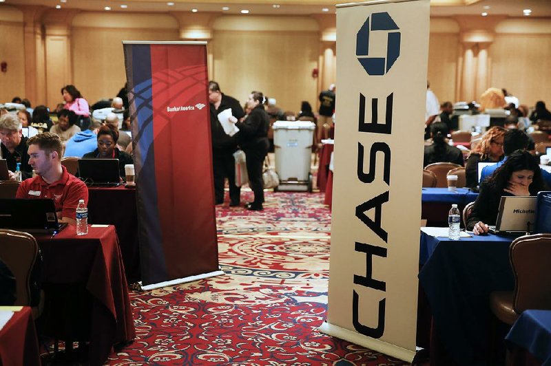 Bank of America Corp. and JPMorgan Chase & Co. signs mark the desks of lender representatives working on home-loan modifications at an event in Los Angeles last month. Federal Reserve Chairman Janet Yellen said Tuesday that regulators may need to tighten rules to prevent risk-taking by the largest U.S. banks.

