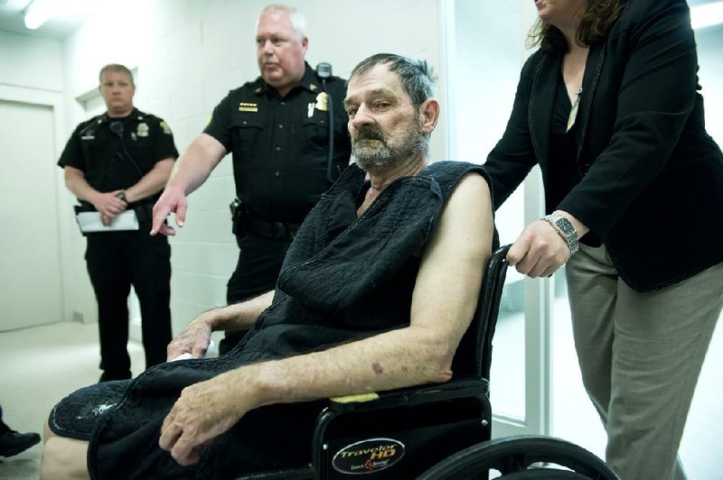 Frazier Glenn Cross appears at his arraignment Tuesday in New Century, Kan. Cross is charged in the shootings that left three people dead at two Jewish community sites in suburban Kansas City on Sunday. 