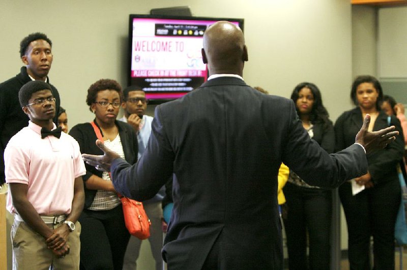 Charles Robinson, the University of Arkansas at Fayetteville’s vice chancellor for diversity and community relations, answers questions from KIPP Delta students on Tuesday at the announcement of a new agreement pledging financial support for a handful of the charter school students to attend the university each year. 