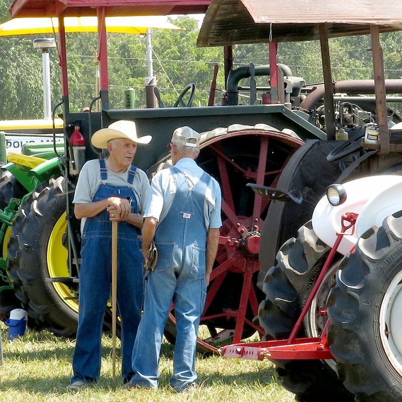 Photo by Randy Moll Tractor enthusiasts visit at a past Tired Iron of The Ozarks show. The show gives visitors a chance to see how people lived and how the land was farmed years ago.