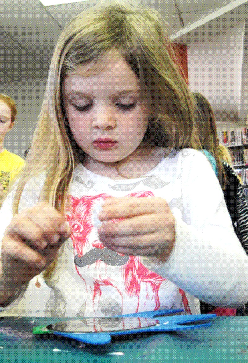 Courtesy of Diane S. Hine Adelynn Scott, 6, crafts a fish suncatcher at the recent First Saturday for Kids program at the Bella Vista Public Libary. For further information on this and other programming, check the library&#8217;s website at www.bvpl.org or call 479-855-1753.