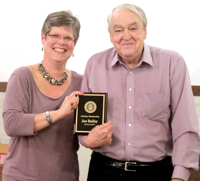 LYNN KUTTER ENTERPRISE-LEADER Jodi Hendricks, president of Farmington Area Chamber of Commerce, honors Joe Bailey with a life-time chamber membership. Bailey was instrumental in starting Farmington&#8217;s chamber organization years ago.