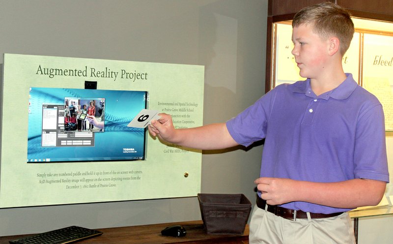 Lynn Kutter/Enterprise-Leader Clayton Weyl, 12, a seventh-grader in the EAST Lab class at Prairie Grove Middle School, demonstrates a new Augmented Reality Project now available in Hindman Hall Museum and Visitor Center at Prairie Grove Battlefield State Park. A ribbon-cutting ceremony to open the hands-on interactive exhibit was held Saturday.