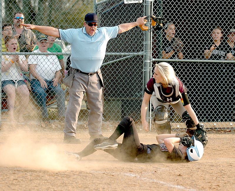 Photo by Randy Moll Gentry&#8217;s Brooke Boston slides in to home plate and is called safe as the ball gets away from Lincoln catcher Lexington Dobbs during a nail biter in Gentry on Thursday. The game went into extra innings.
