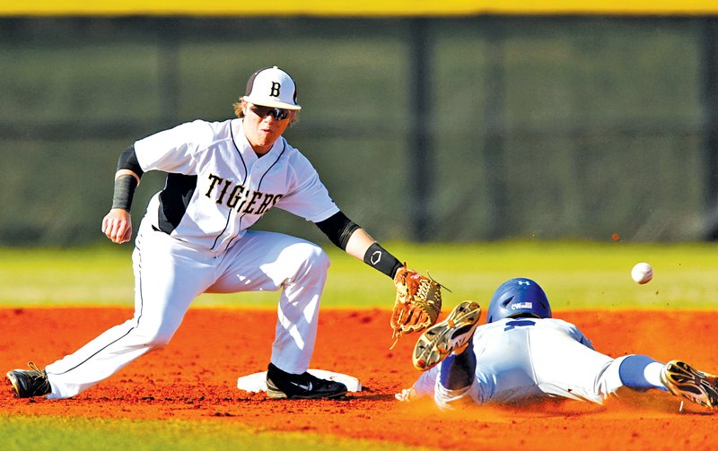  STAFF PHOTO JASON IVESTER Timmy Seldomridge of Rogers High safely slides into second Tuesday as the ball gets past Bentonville's Blake Werner during the game at Bentonville.