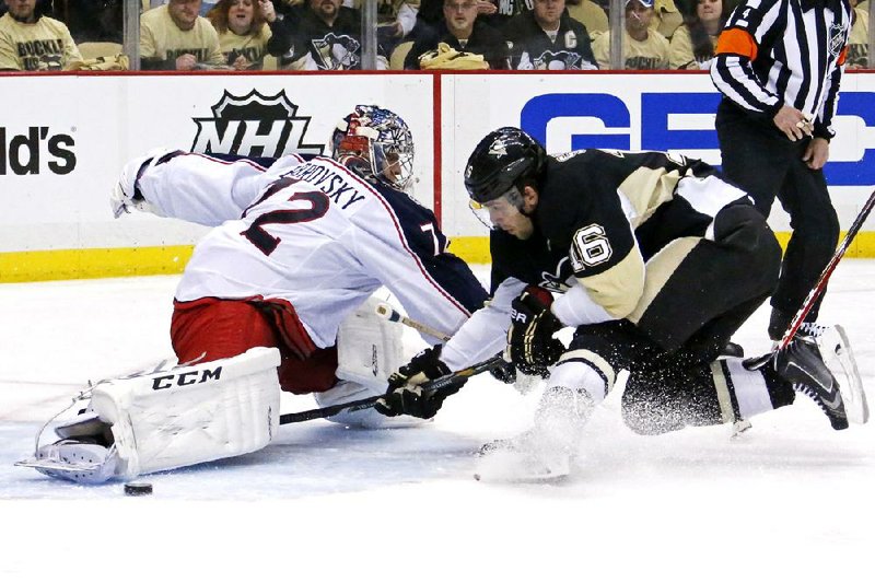 Brandon Sutter (right) of the Pittsburgh Penguins tries to get a shot past Columbus Blue Jackets goalie Sergei Bobrovsky during the second period of their first-round NHL playoff game Wednesday night in Pittsburgh. 