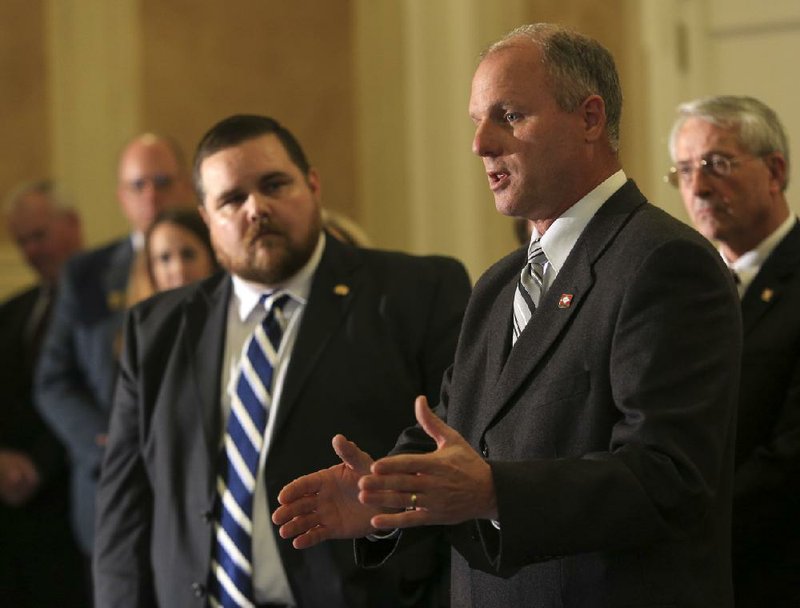 Sen. Jim Hendren, R-Sulphur Springs and task force chairman, said he likely will request that Gov. Mike Beebe call a special session of the Legislature to address the issue if the task force recommends eliminating coverage for employees who work fewer than 30 hours a week.  Sen. Jim Hendren is shown along with Rep. Bob Ballinger (left), R-Hindsville in this file photo. 