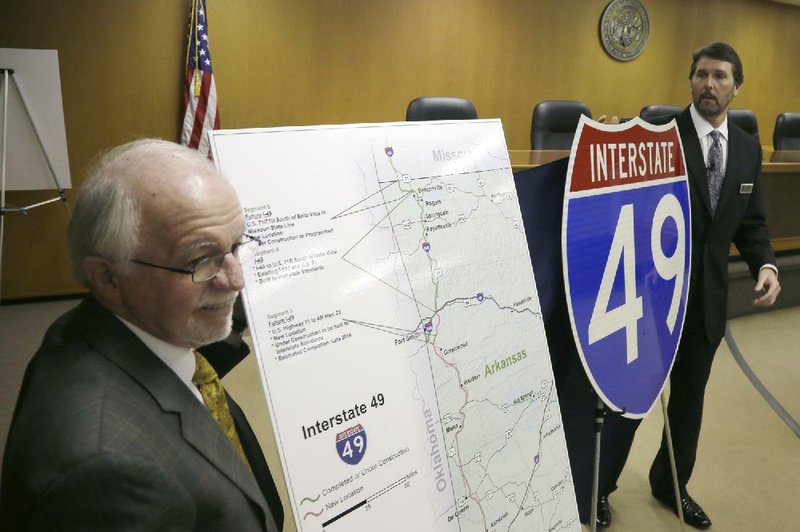 Vice Chair of the Arkansas Highway Commission Dick Trammel of Rogers, left, and Arkansas State Highway and Transportation Department Director Scott Bennett unveil an Interstate 49 sign at Highway Department headquarters in Little Rock on Wednesday. Most of Interstate 540 from Interstate 40 at Alma north to the Missouri state line will be renamed I-49 beginning next week. 