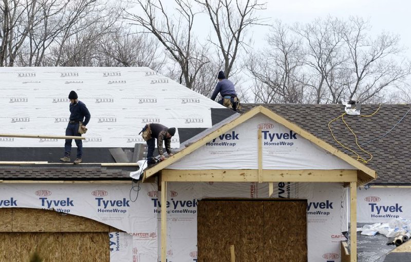 Roofers work on a new house in Pepper Pike, Ohio, in March. Home construction in the United States rose moderately last month, the Commerce Department said Wednesday. 