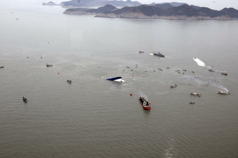 As the ferry Sewol lies beneath chilly waters off South Korea’s southern coast Wednesday, rescue and fishing boats try to save passengers. 