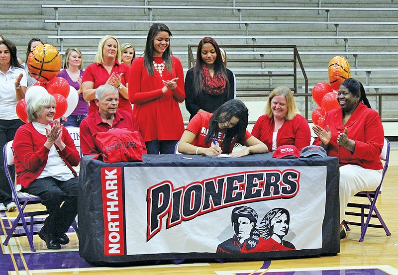 SUBMITTED PHOTO Skyler Johnson of Elkins signs Wednesday to play basketball at North Arkansas Community College during a ceremony in the Elkins gymnasium.