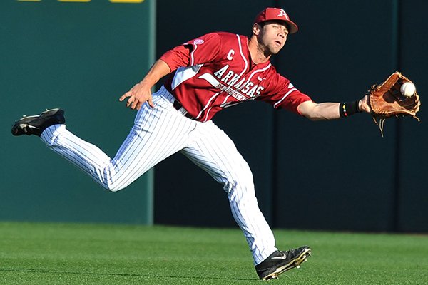 Arkansas center fielder Tyler Spoon runs down a fly ball for an out in the first inning of a game Saturday, April 5, 2014 against South Carolina at Baum Stadium in Fayetteville.
