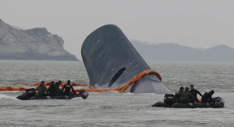 South Korean Coast Guard officers search for missing passengers aboard a sunken ferry in the waters off the southern coast near Jindo, South Korea, on Thursday, April 17, 2014. An immediate evacuation order was not issued for the ferry, likely with scores of people trapped inside, because officers on the bridge were trying to stabilize the vessel after it started to list amid confusion and chaos, a crew member said Thursday.