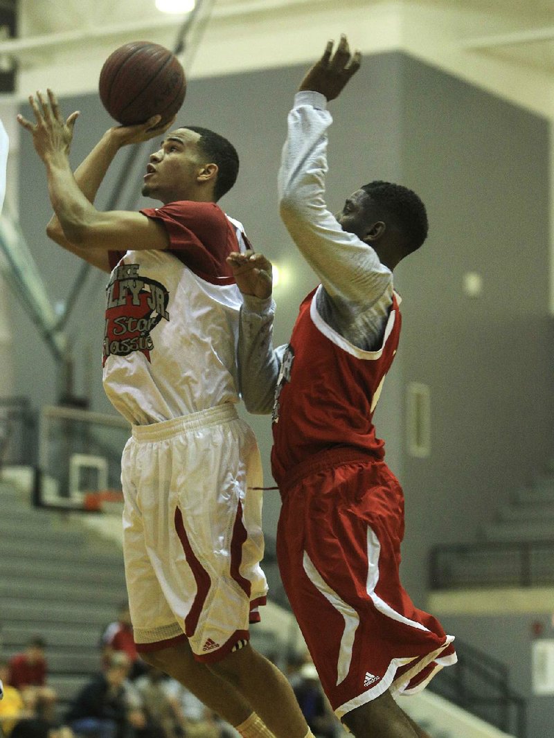 Guard Nick Babb (left), who has signed with the Arkansas Razorbacks, shoots as Tennessee’s Davell Roby defends him Thursday night in the Mike Conley Jr. Arkansas vs. Tennessee All-Star Classic at Little Rock Hall. The game served as a kickoff for the Real Deal in the Rock, which begins tonight.