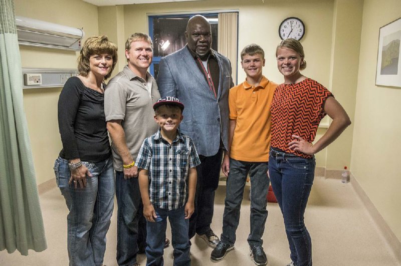 Members of the Burpo family — Sonja (from left), Todd, Colby, Colton and Cassie — pose with Bishop T.D. Jakes, who is one of the producers of Heaven Is for Real, a movie based on Todd’s nonfiction book about Colton’s visions of the afterlife. 