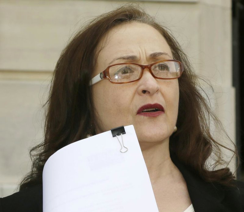 Rita Sklar, executive director of the ACLU of Arkansas, discusses the group’s lawsuit challenging the state’s voter-identification law Wednesday outside the Pulaski County Courthouse. 