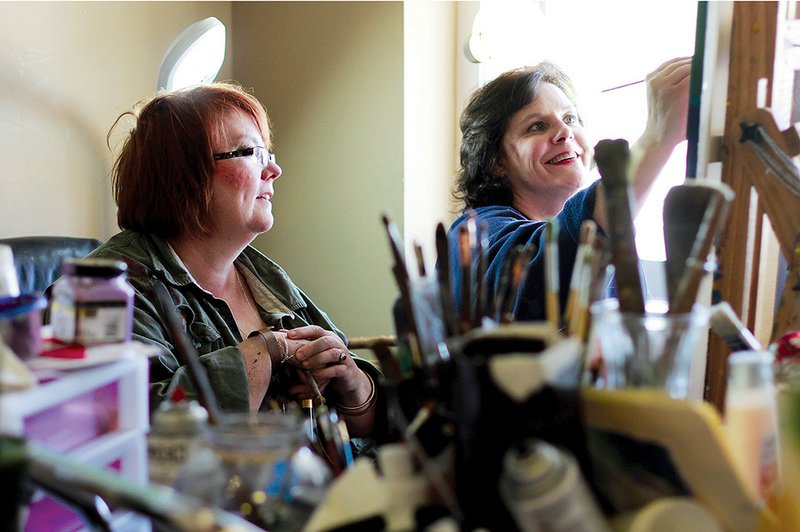 Ellen Hobgood, left, gives an art lesson to Meredith Karr in Hobgood’s Heber Springs gallery. Hobgood will be part of the artists’ block party during Springfest.