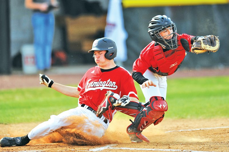 STAFF PHOTO ANDY SHUPE Adam Ness of Farmington slides in safely Thursday at the plate as Pea Ridge catcher Blake Cotton fields the late during the first inning in Farmington.