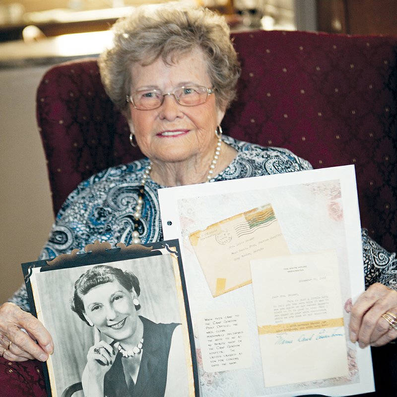 Robie Popham Permenter of Vilonia holds an autographed photograph of Mamie Eisenhower and notes Permenter keeps in an album reflecting the 50 or so years she served as a beauty operator.