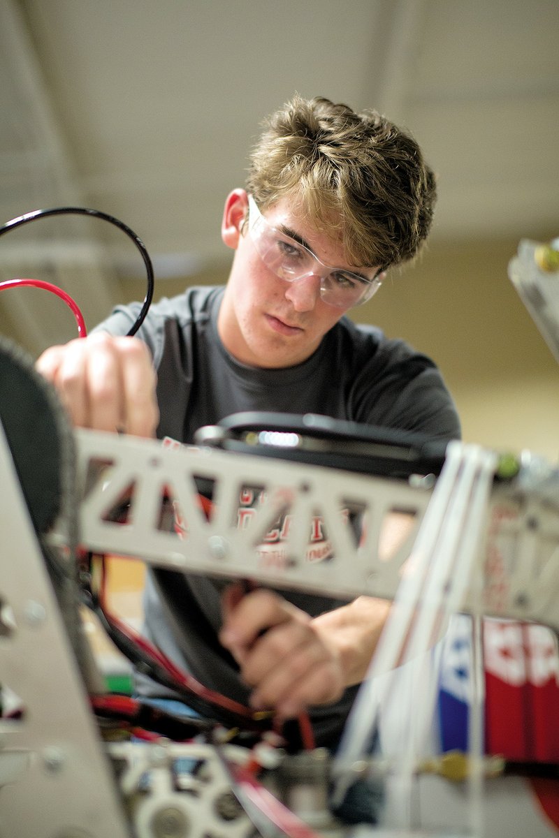 Joseph Walker, a senior on the Harding Academy robotics team, works on rewiring an arm on the team’s robot. The team took the arm to use for spare parts at the team’s most recent competition.