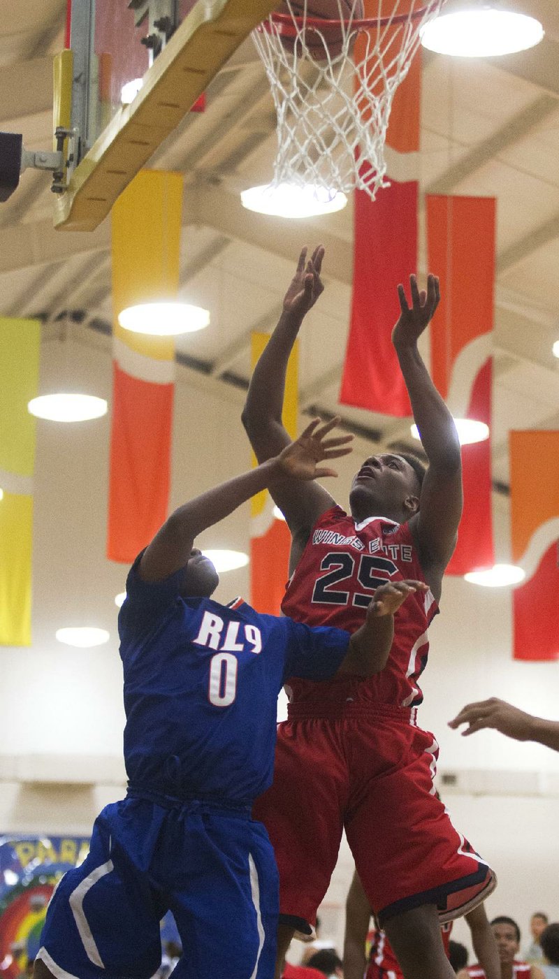 Arkansas Democrat-Gazette/MELISSA SUE GERRITS - 04/18/2014 - Wings Elite's Victor Dukes makes a 3 pointer  with RL9 defender (no first name on awesome roster) Collins during their game against RL9 at the Real Deal tournament in Little Rock, April 18, 2014. 