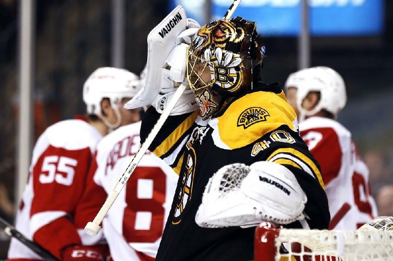 Boston Bruins goalie Tuukka Rask grimaces as Detroit Red Wings celebrate Pavel Datsyuk's goal during the third period of Detroit's 1-0 win in Game 1 of a first-round NHL playoff hockey game in Boston on Friday, April 18, 2014. (AP Photo/Winslow Townson)