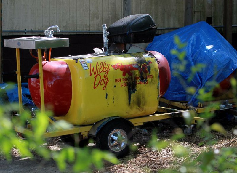 A charred hot-dog cart sit outside the Bragg Street home of Ean Bordeaux after an altercation Friday between the hot-dog vendor and a former Little Rock police officer who died afterward. Video is available at arkansasonline.com/video 