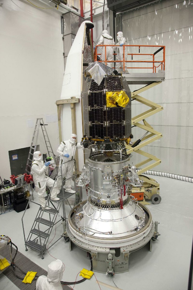 In this Aug. 20, 2013 photo provided by NASA, engineers prepare to install the Lunar Atmosphere and Dust Environment Explorer (LADEE) spacecraft into the fairing of the Minotaur V launch vehicle nose-cone at NASA's Wallops Flight Facility in Wallops Island, Va. On Friday, April 18, 2014, flight controllers confirmed that the orbiting spacecraft crashed into the back side of the moon as planned, just three days after surviving a full lunar eclipse, something it was never designed to do. During its $280 million mission, LADEE identified various components of the thin lunar atmosphere  neon, magnesium and titanium, among others  and studied the dusty veil surrounding the moon, created by all the surface particles kicked up by impacting micrometeorites. (AP Photo/NASA, Terry Zaperach)